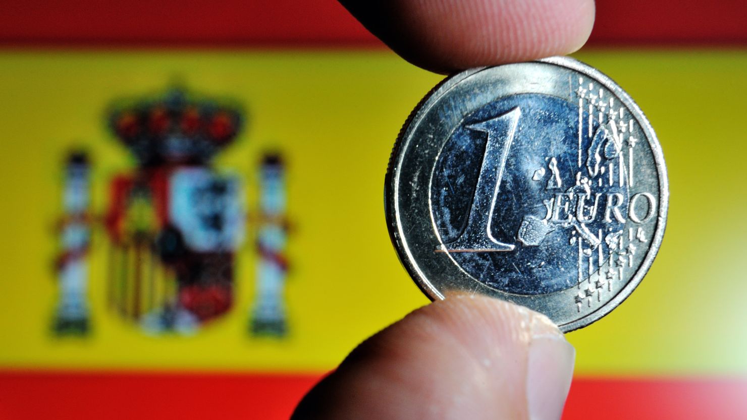 A file photo of the euro coin and the Spanish flag.