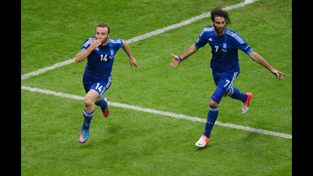 Dimitris Salpigidis and Georgios Samaras of Greece celebrate their first goal against Poland.