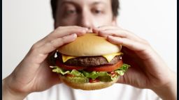 Man eating hamburger close-up