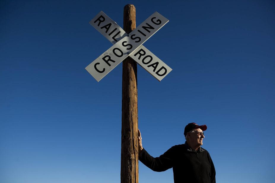 Historian Richard Dean stands next to a sign by the old railroad tracks. Dean runs the Columbus Historical Society and Old Railroad Depot Museum and has helped establish historical markers around the town, most of which feature the raid by Pancho Villa and his army in 1916. Dean's great-grandfather was shot and killed in the raid.