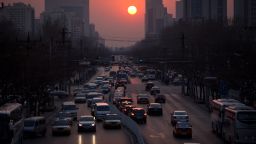 The sun sets over traffic in Beijing on March 25, 2012. 