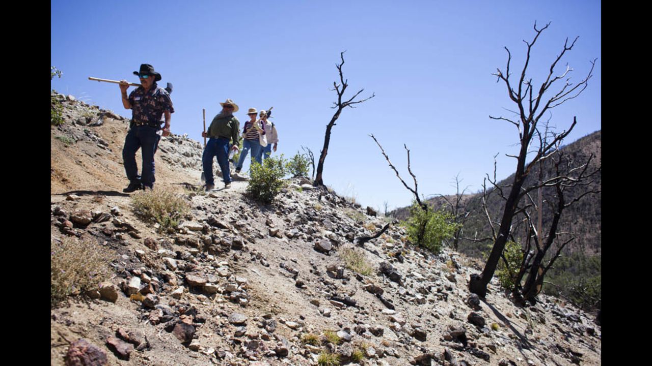 Volunteers hike through Coronado National Forest. About a hundred volunteers joined the Tombstone Shovel Brigade, hiking up the mountain to help move and bury the line that supplies Tombstone with water.
