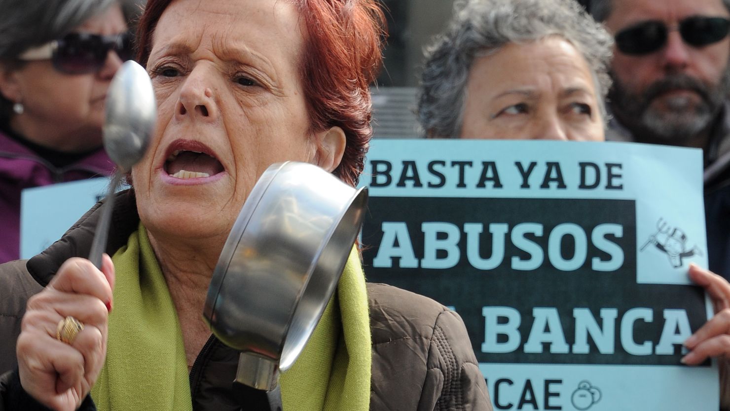 A protester holds a banner reading "Enough of the banking abuses" during a demonstration outside Bankia HQ in March.