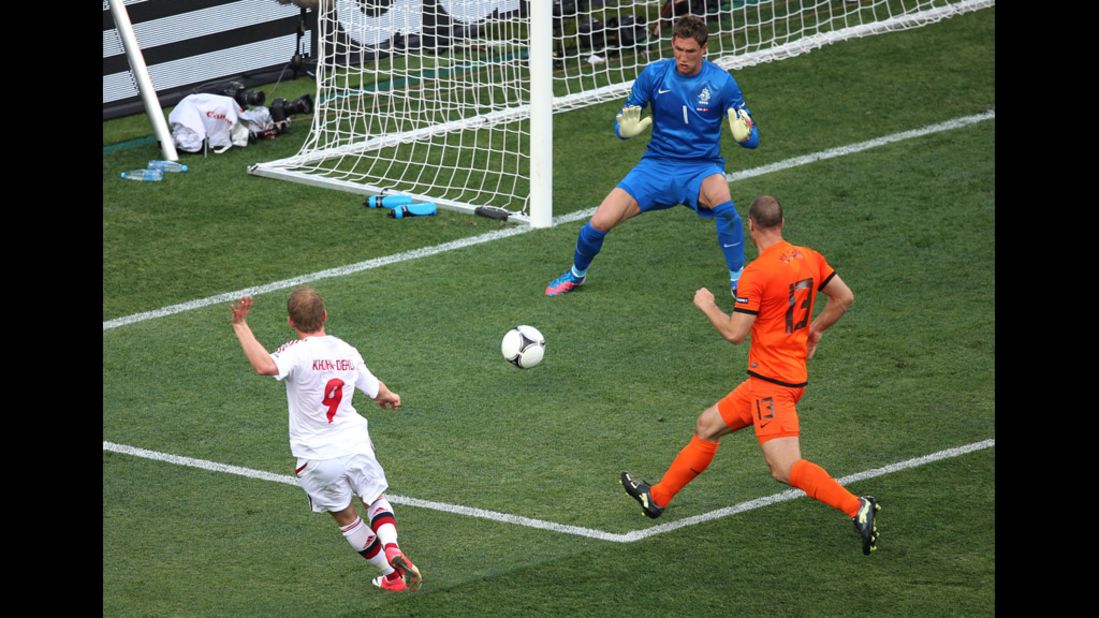 Michael Krohn-Dehli of Denmark scores the team's first goal past Maarten Stekelenburg of the Netherlands during a Group B match Saturday.
