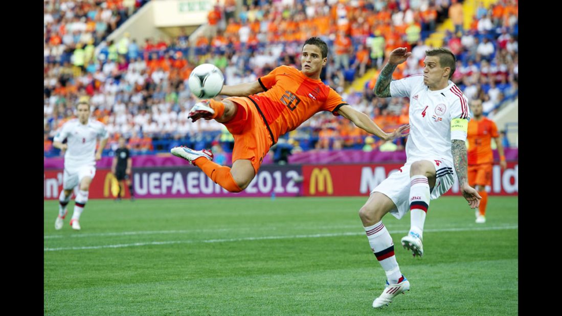 Ibrahim Afellay of the Netherlands goes airborne as Daniel Agger of Denmark defends.