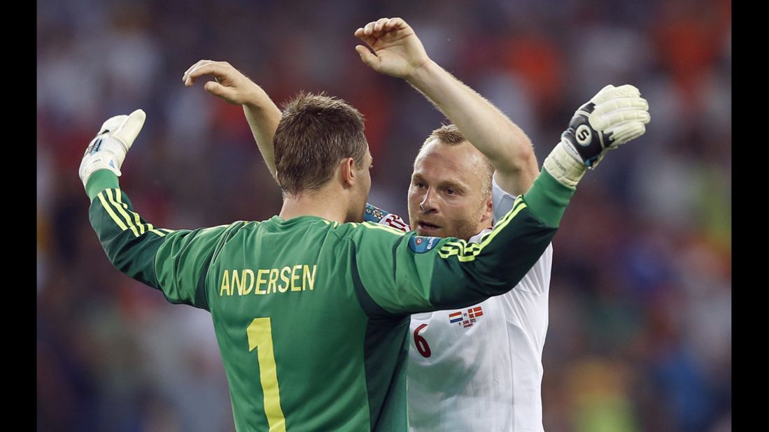 Goalkeeper Stephan Andersen of Denmark celebrates with teammate Lars Jacobsen during the match against the Netherlands.