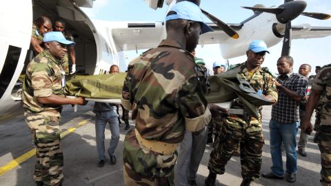 U.N. troops carry on a stretcher the body of one of the seven UN peacekeepers from Niger who were killed in an ambush.