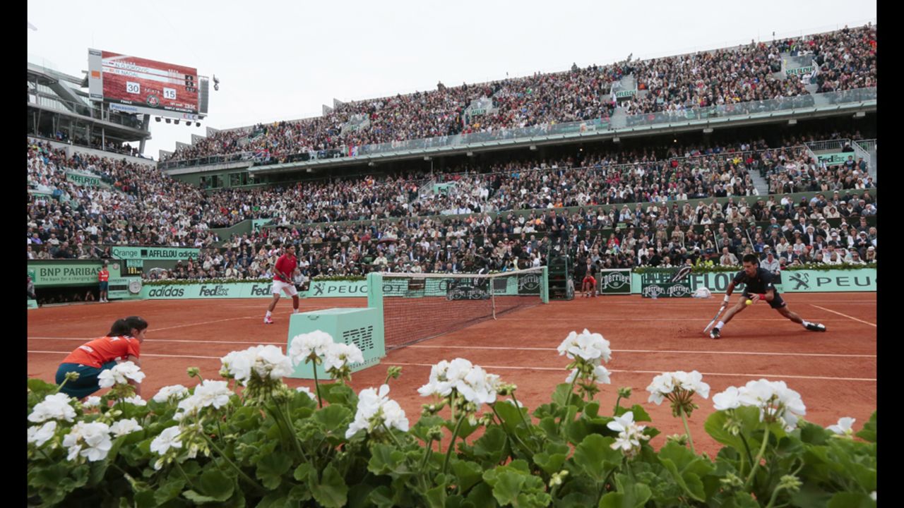Djokovic and Nadal volley during Sunday's match, which was delayed twice because of rain and finished Monday.