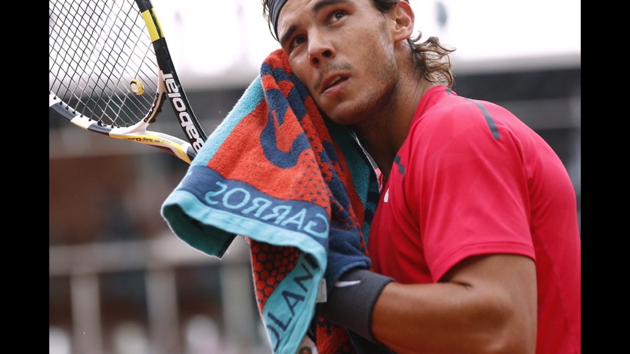 Nadal dries his face during the third set of the match.