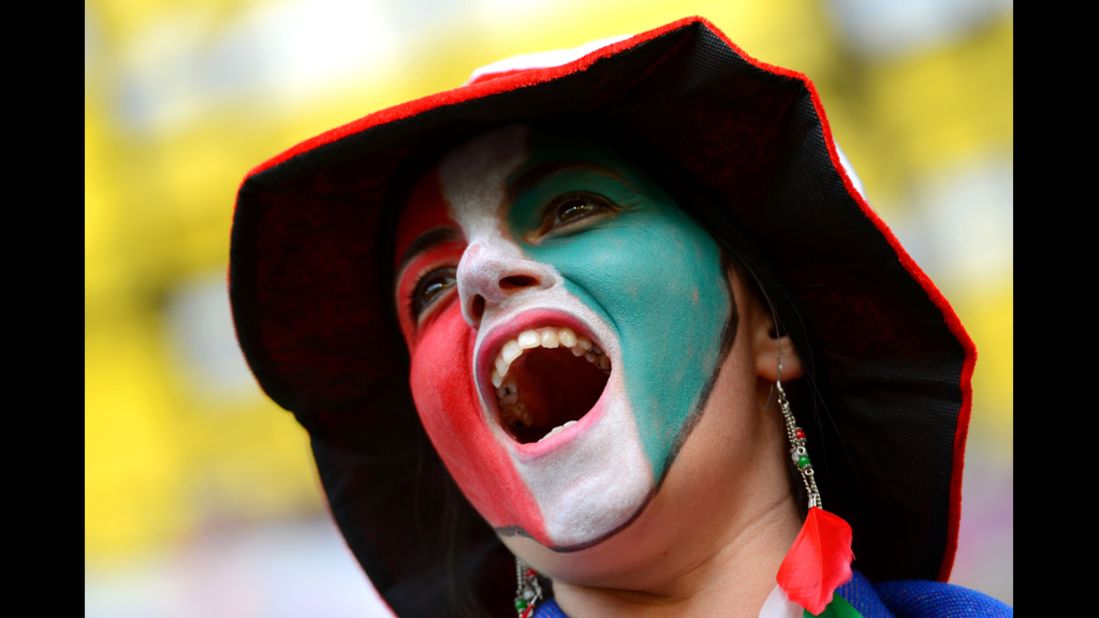 An Italy fan cheers before Sunday's match against Spain.