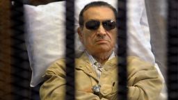 Ousted Egyptian president Hosni Mubarak sits inside a cage in a courtroom during his verdict hearing in Cairo on June 2, 2012. A judge sentenced Mubarak to life in prison after convicting him of involvement in the murder of protesters during the uprising that ousted him last year. AFP PHOTO/STR (Photo credit should read STR/AFP/GettyImages)