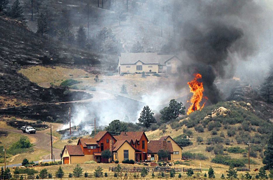 Flames threaten houses on the eastern front of the High Park fire near Laporte on Sunday, June 10. 