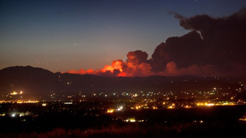 The sprawling wildfire lights up the night sky Saturday in a photo from CNN iReporter Randy S. Macht taken in Louisville, Colorado, south of the blaze.