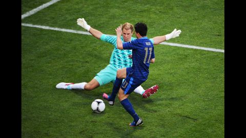 Goalkeeper Joe Hart of England blocks Samir Nasri of France during the Group D match in Donetsk, Ukraine, Monday, June11.
