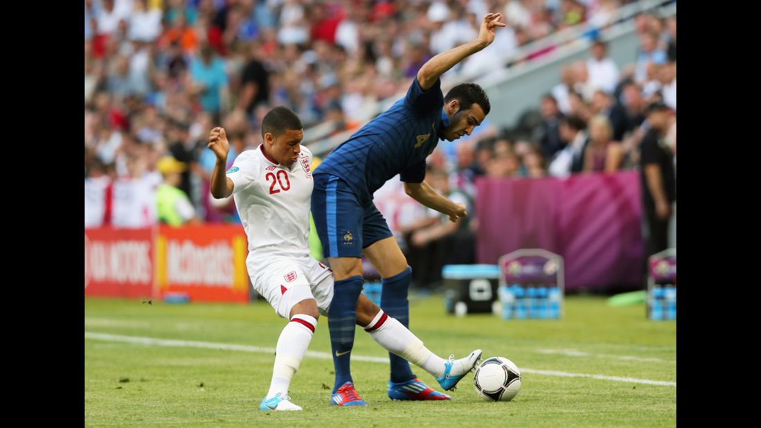 Alex Oxlade-Chamberlain of England and Adil Rami of France fight for possession.