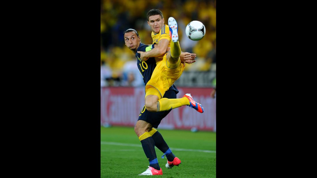 Yevhen Selin of Ukraine and Zlatan Ibrahimovic of Sweden battle for the ball.