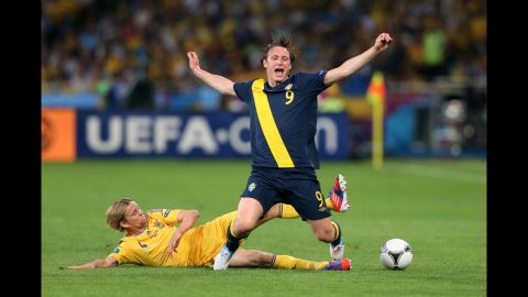 Ukraine's Anatoliy Tymoshchuk tackles Kim Kallstrom of Sweden.