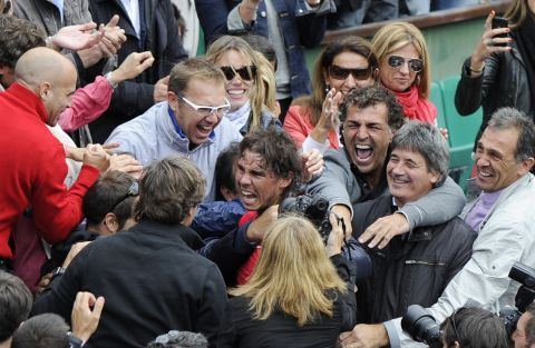 Rafael Nadal celebrates with his family and coaching staff after entering the history books at the French Open.