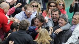 Rafael Nadal celebrates with his family and coaching staff after entering the history books at the French Open.