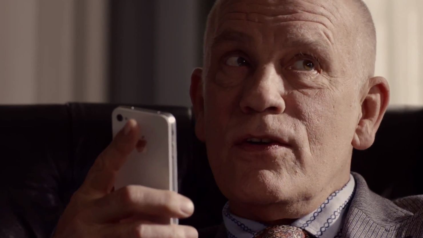 Actor John Malkovich talks to his iPhone 4S in a current TV ad for Apple.