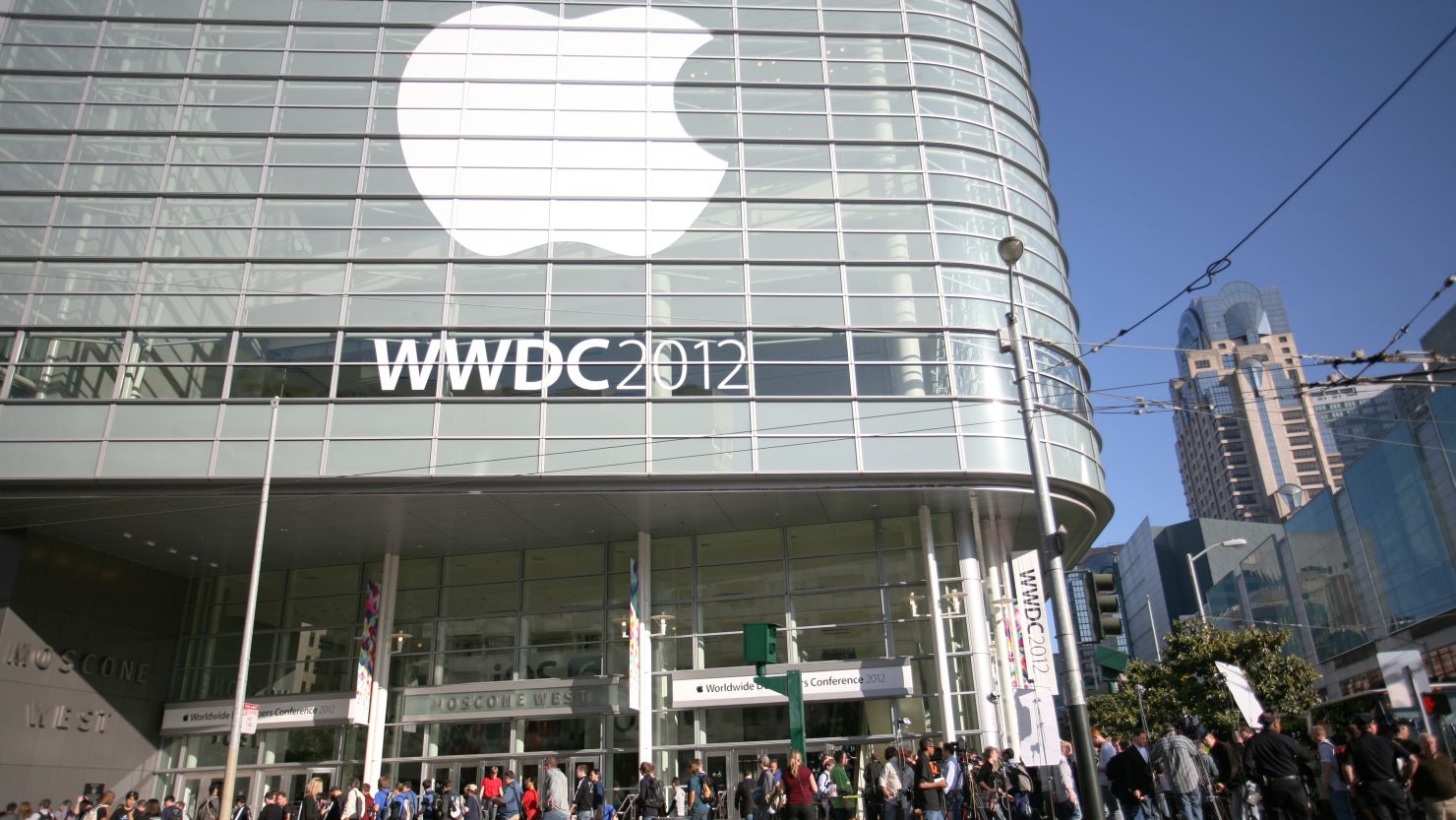 Attendees of Apple's Worldwide Developers Conference wait outside the Moscone Center in San Francisco on Monday.