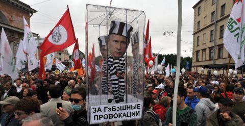 Opposition activists carry a carry a model of a prison cell with the cut-out figure of Putin during a rally in St. Petersburg.