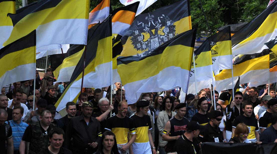 Nationalists carry the black-yellow-white flags of the Russian Empire as they take part in an anti-Putin rally in Moscow.