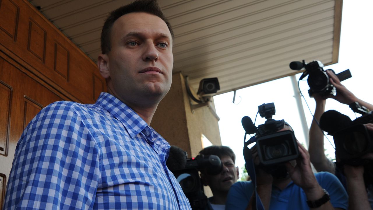 Russian anti-corruption blogger Alexei Navalny stands a the entrance to a Federal Investigative Commision office in Moscow, on June 12, 2012, as he arrives for questioning, a part of a probe into last month's demonstration with bloody battles between riot police and the mostly young crowd. Russian President Vladimir Putin's foes vowed today to defy a wave of police raids and the threat of fines the size of their annual salaries to join a monthly march against his 12-year rule. AFP PHOTO / ANDREY SMIRNOV (Photo credit should read ANDREY SMIRNOV/AFP/GettyImages) 