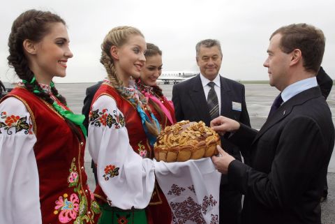 Ukrainian cuisine is known for its simplicity. Bread is a main part of the national diet and the country has been known as the 'breadbasket of Europe'. Pictured: Former Russian president Medvedev receieves a tradtional greeting arriving in Ukraine in 2010.