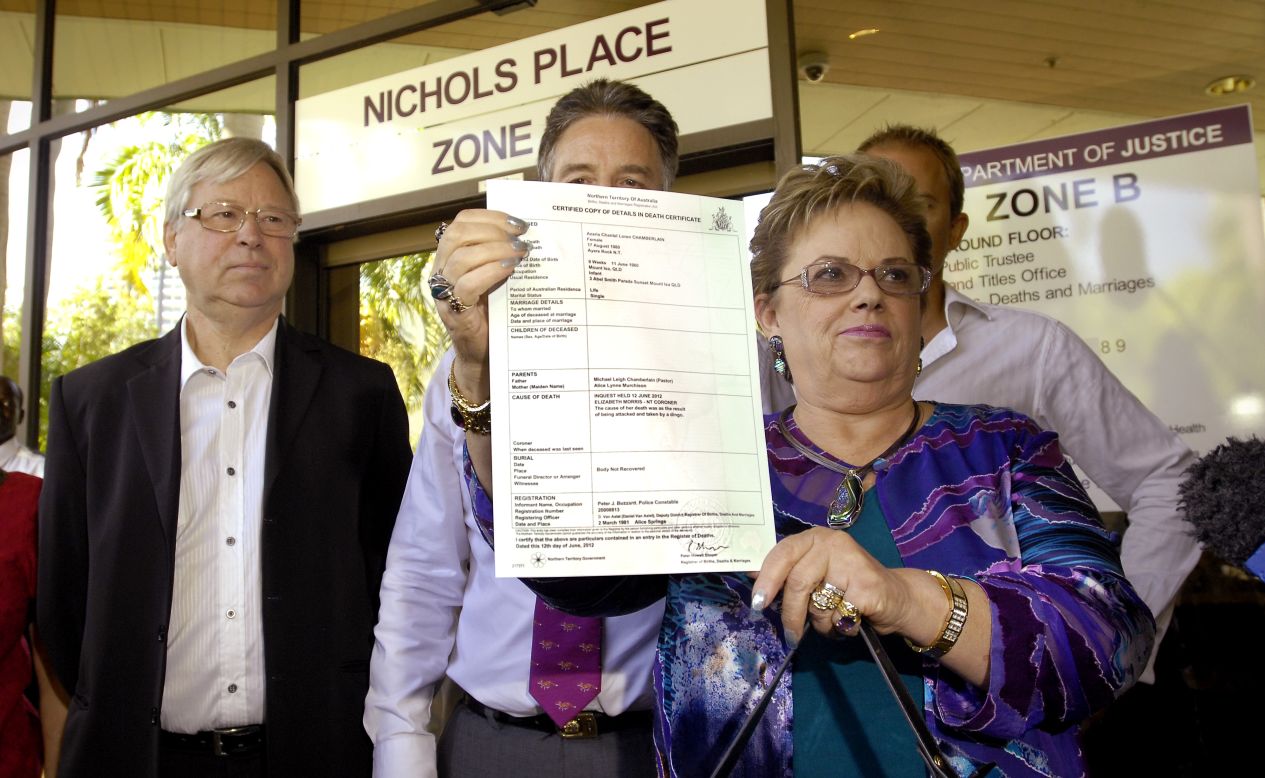Lindy Chamberlain-Creighton shows reporters Azaria's death certificate outside a Darwin court Tuesday after coroner Elizabeth Morris rules that a dingo caused her baby's death 32 years ago.