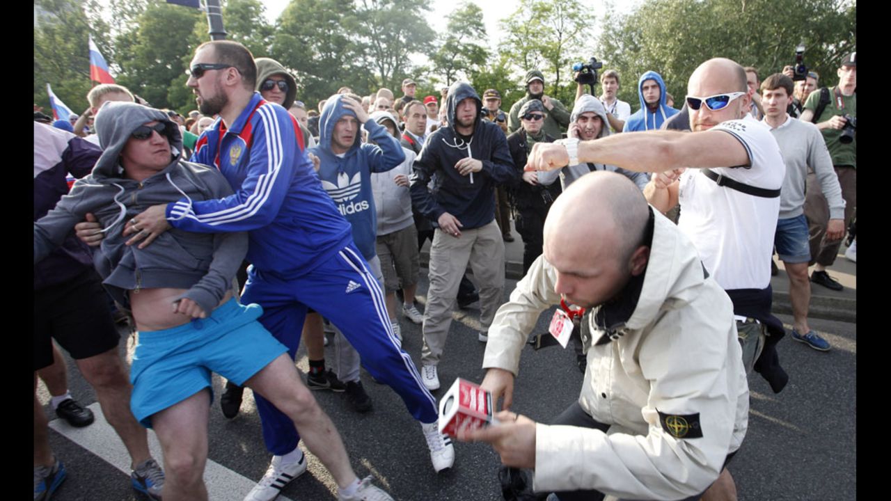A Polish journalist, second right, is beaten by football fans in Warsaw.