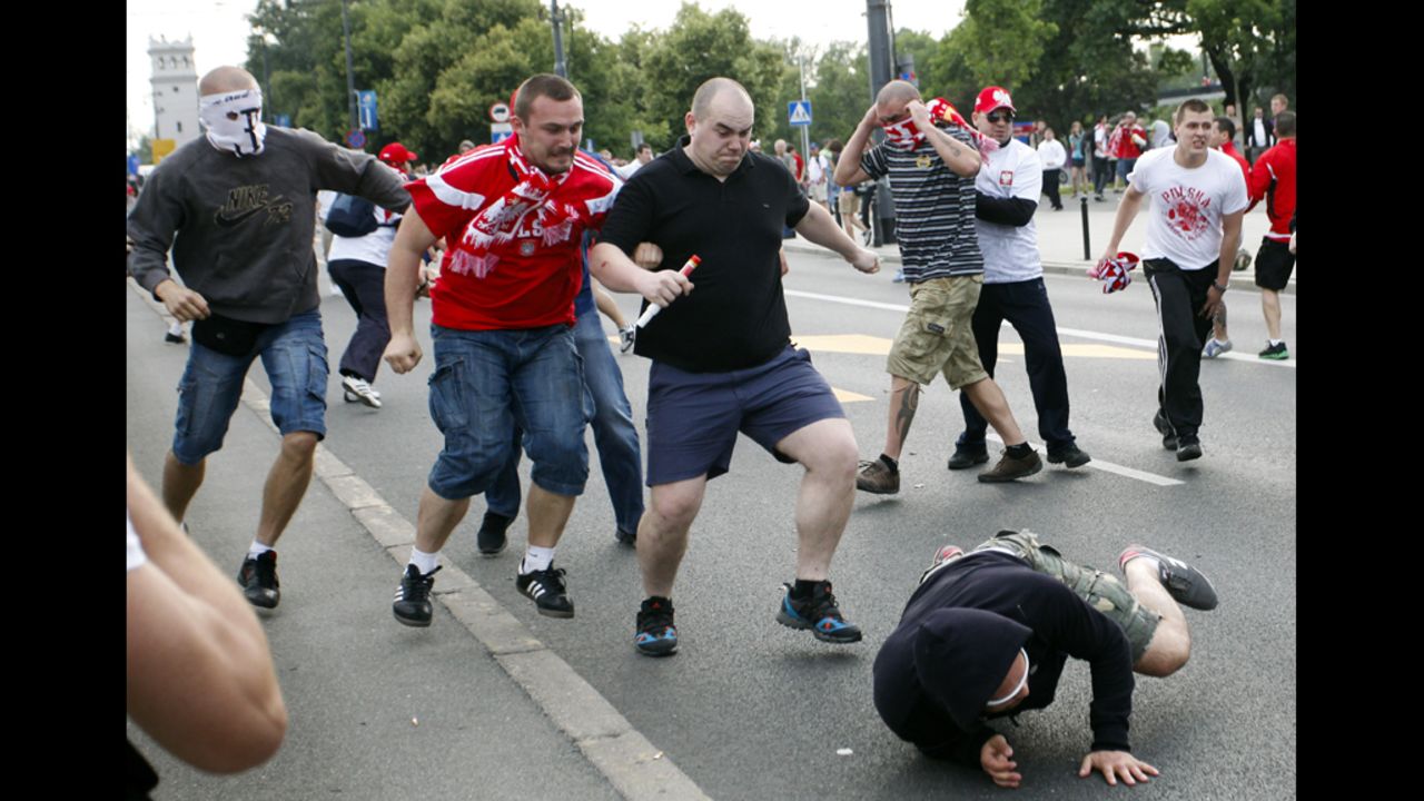 Polish and Russian soccer fans clash outside of the National Stadium in Warsaw.