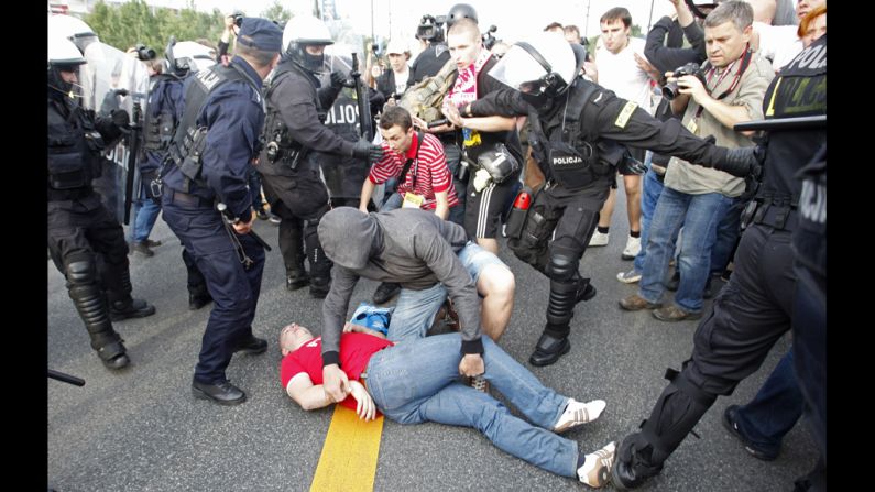  A Polish soccer fan lies on the ground after clashing with Russian supporters.