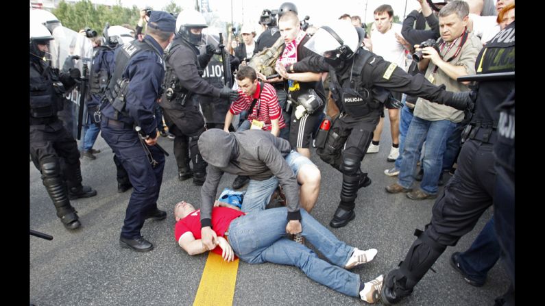  A Polish soccer fan lies on the ground after clashing with Russian supporters.