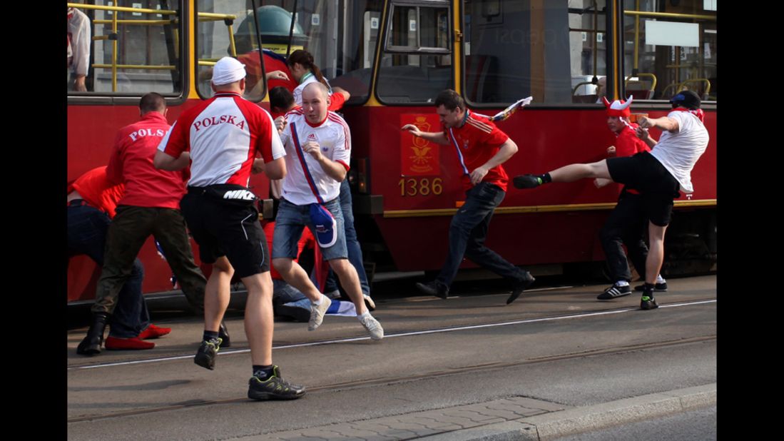 Polish and Russian soccer fans fight before the match between Russia and Poland.