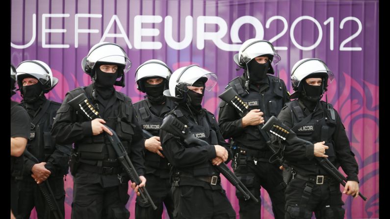 Polish riot police stand guard during clashes with soccer fans in front of the National Stadium before the match between Poland and Russia.