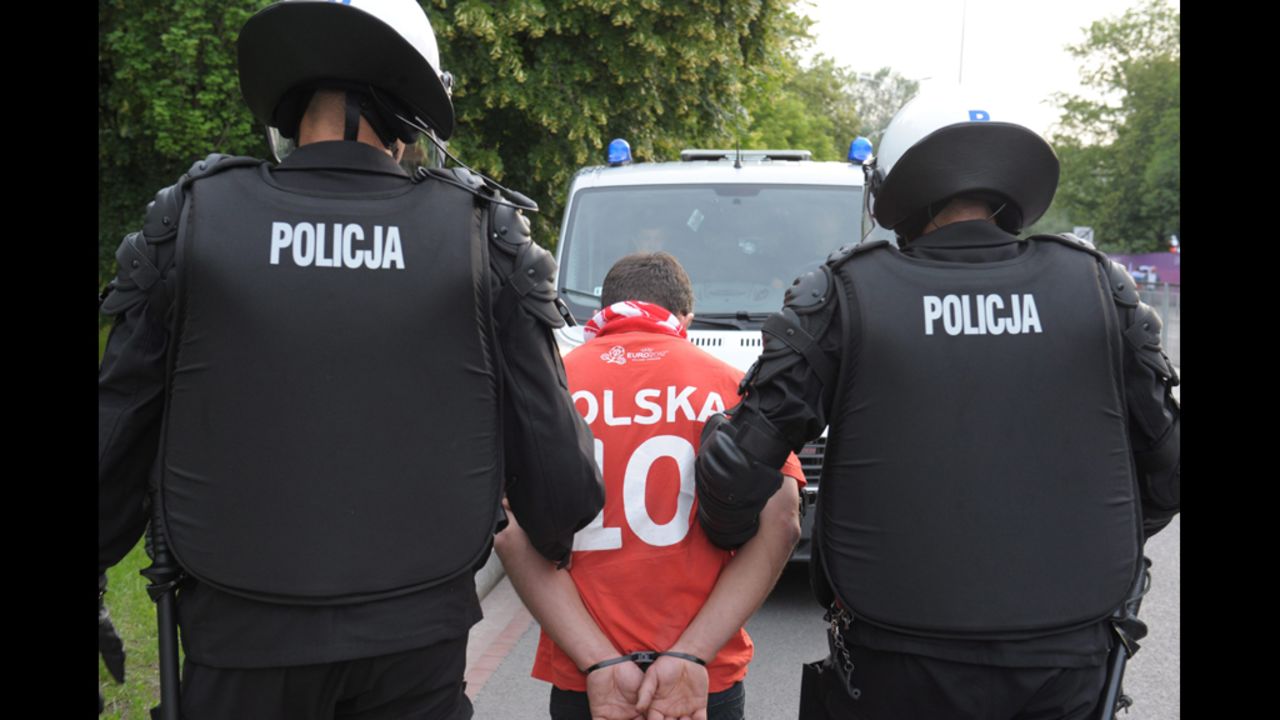  A Polish fan is arrested by police before the Russia-Poland match.