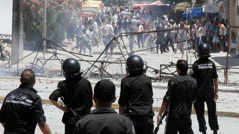 Demonstrators clash with police in Intilaka, outside Tunis, on Tuesday. 