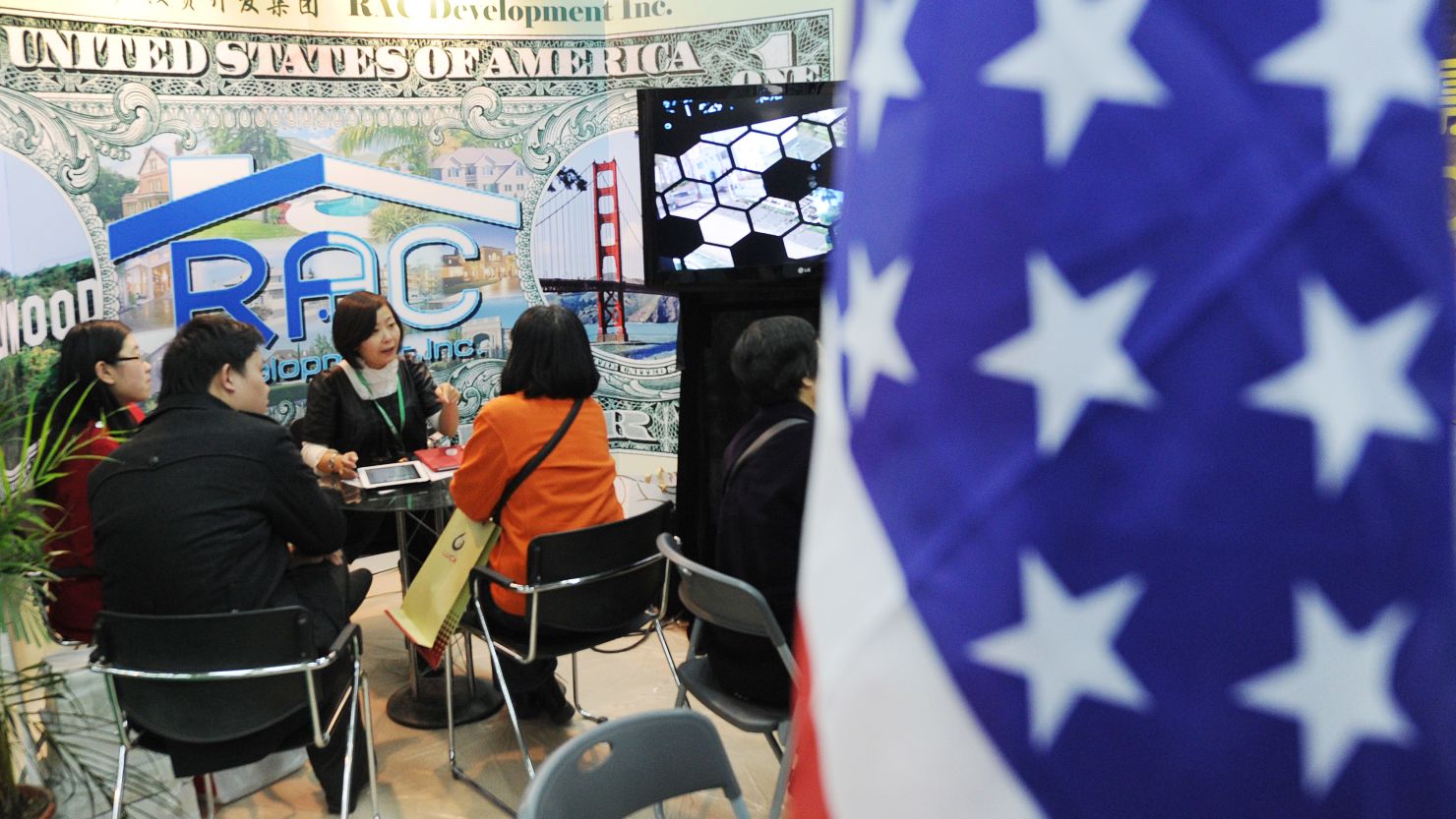 	Potential Chinese real estate investors look at a display of United States property for sale at the Overseas and China Property Expo in Beijing on April 5, 2012. 