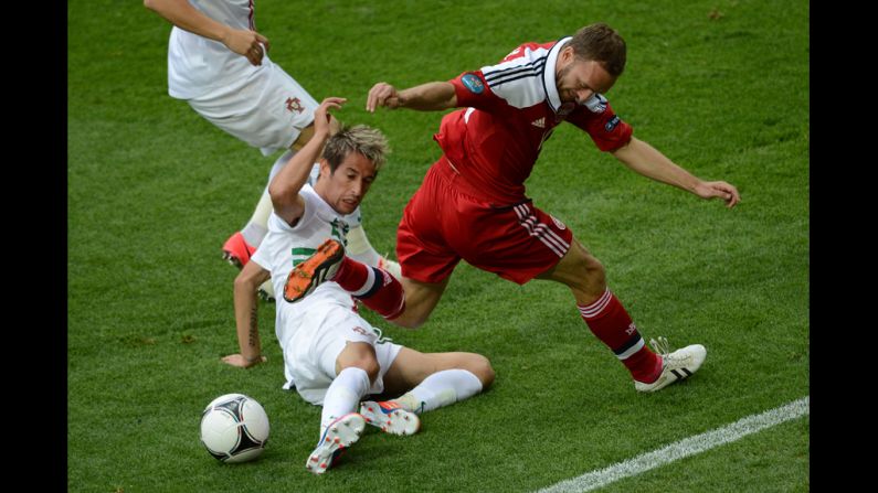 Dennis Rommedahl of Denmark fights for possession with Fabio Coentrao of Portugal.