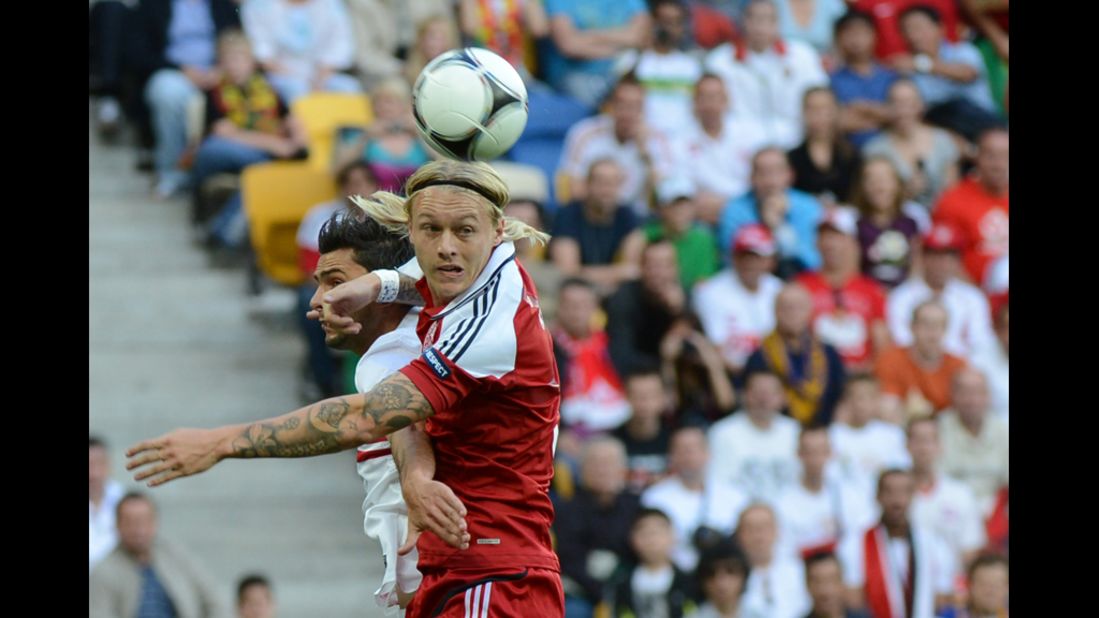 Denmark's Simon Kjær battles for a header against Helder Postiga of Portugal on Wednesday.