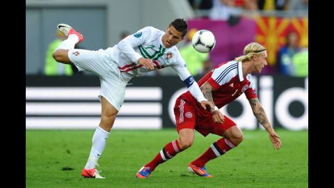 Cristiano Ronaldo of Portugal clashes with Simon Kjær of Denmark during the Group B match between Portugal and Denmark.
