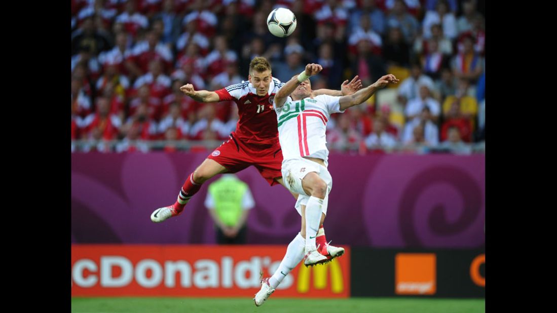 Nicklas Bendtner of Denmark beats Pepe of Portugal to head in Denmark's second goal.