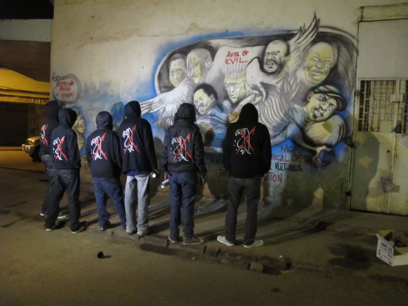 The graffiti gang steps back and admires their latest work. Each wears the 'anti-vulture' jacket.