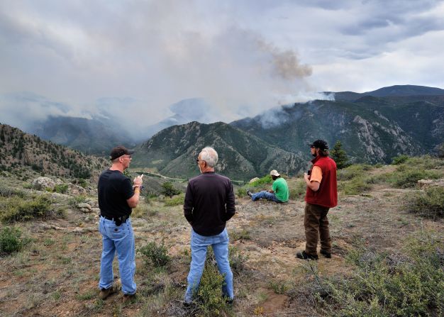 Residents watch the approaching fire Tuesday in the Roosevelt National Forest west of Fort Collins.