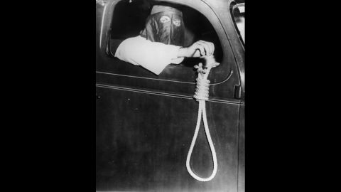 A Klan member hangs a noose out of a car window to intimidate black voters in Miami in 1939. Members drove 75 cars through the streets that day.