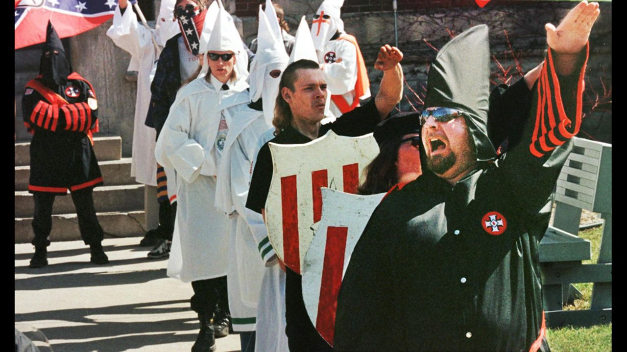 Ku Klux Klan members chant "white power" during a rally to recruit members on the steps of the Defiance, Ohio, courthouse in 1999.
