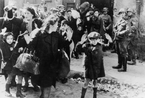 This image shows terrified women and children from the Warsaw ghetto in Nazi-occupied Poland surrendering to German soldiers after a failed uprising in1943.