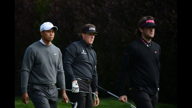 From left, Tiger Woods, Phil Mickelson and Bubba Watson wait on the 13th tee during the first round.The trio teed off together in what many called a "super group."