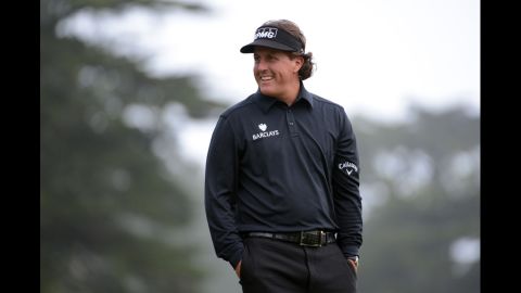 Mickelson reacts after his putt on the ninth hole Thursday.